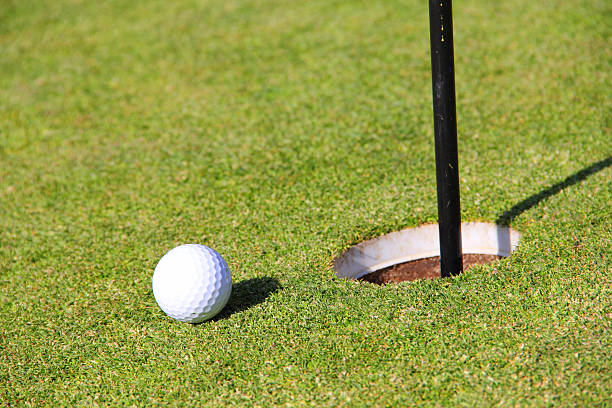 istock Golf ball on lip of cup 505444153
