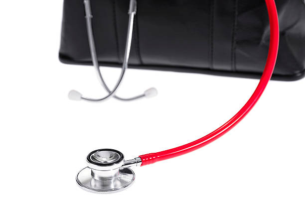 istock Red stethoscope and a Doctor's bag on a white background 505463664