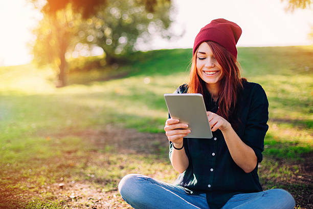 istock Girl with digital tablet outdoors 505464594