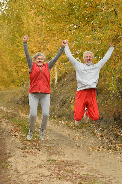 istock Happy fit senior couple jumping 505464846