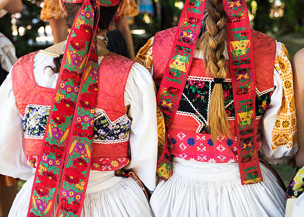 istock Anonymous girls in folklore costumes, back detail 505465038