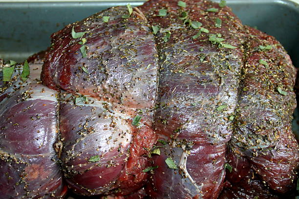 istock Raw Venison leg joint, herbs and spices, ready to cook 505465044
