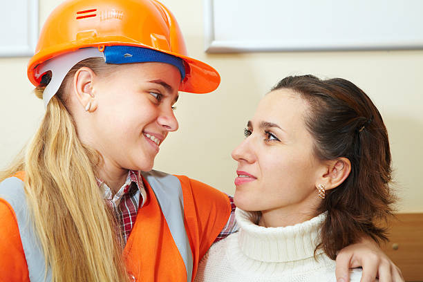 Young contractor with mother in office stock photo