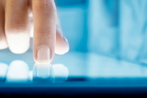 Woman using digital tablet Woman hand touching screen digital tablet pc. Closeup shot. Small depth of field. Soft focus. extreme close up stock pictures, royalty-free photos & images