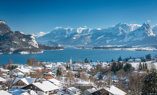 The beautiful and famous Wolfgangsee with St. Gilgen covered in fresh Snow. Wide Panorama with great Detail.