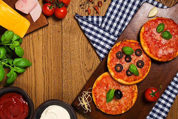 istock Mix of mini pizzas on wooden board 505468026