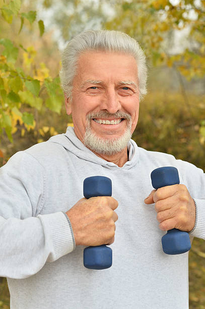istock Elderly man exercising with dumbbells 505468410
