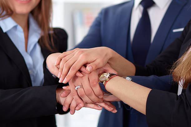 istock Business people group joining hands 505470534