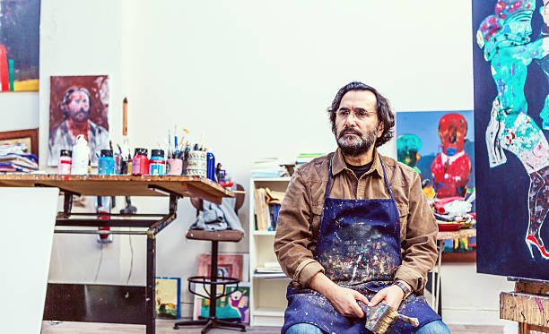Painter Sitting Front of Easel in Art Sudio