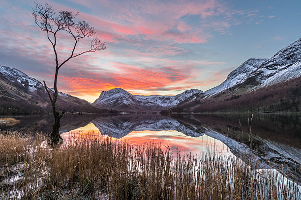 istock Vibrant Sunrise At Buttermere With Reflections And Snow On Mountains. 505471436
