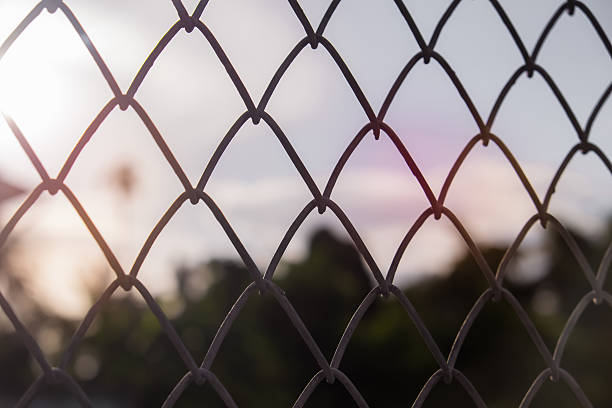 istock Wire fence with futsal field on background 505471769