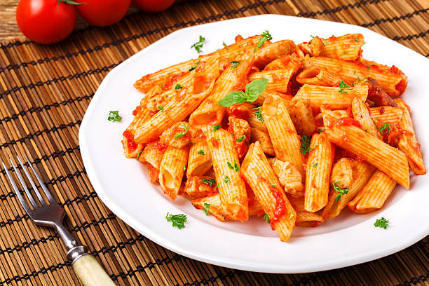 istock Penne with roasted chicken in tomato sauce 505472002