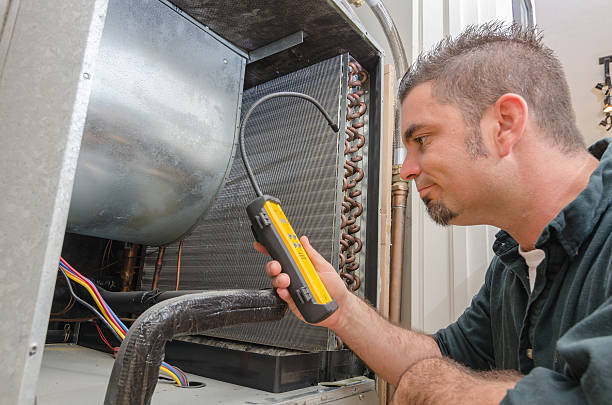HVAC Technician with Leak Detector An Hvac technician searching for a refrigerant leak on an evaporator coil. snorting stock pictures, royalty-free photos & images