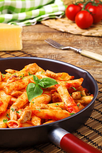 istock Penne with roasted chicken in tomato sauce 505472244