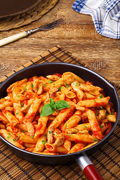 istock Penne with roasted chicken in tomato sauce 505472362