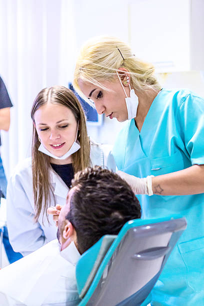 istock Dentist With Patient in Surgery 505473874