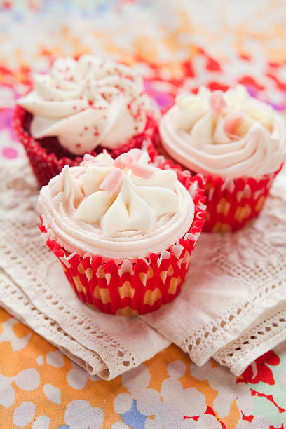 istock White chocolate fruit cupcakes in red paper 505474200