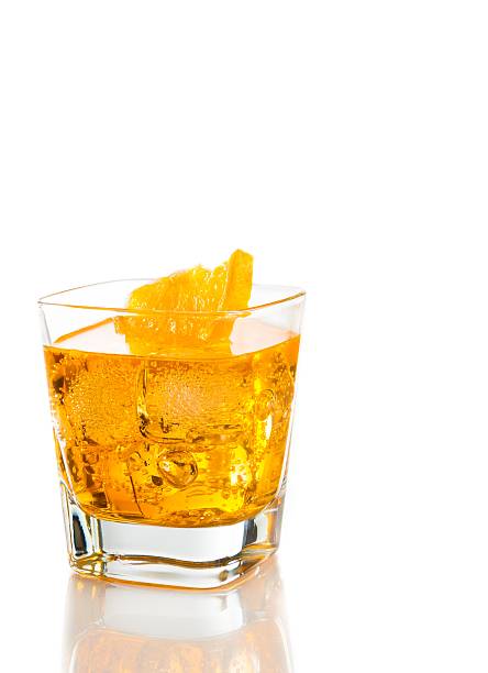 istock yellow cocktail with orange slice isolated on white background 505475204