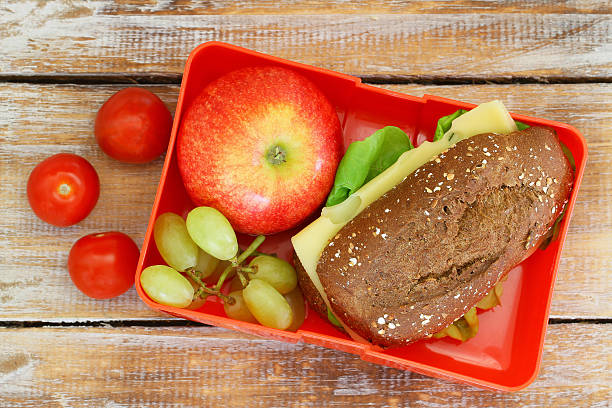 istock Healthy school lunch box containing cheese roll, cherry tomatoes, fruit 505475496