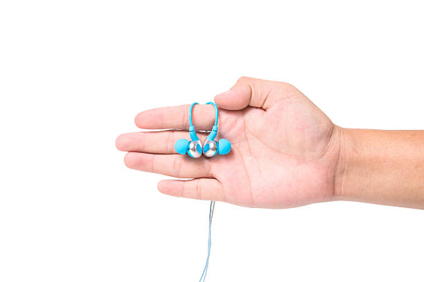 istock hand holding earphones isolated on white 505475644