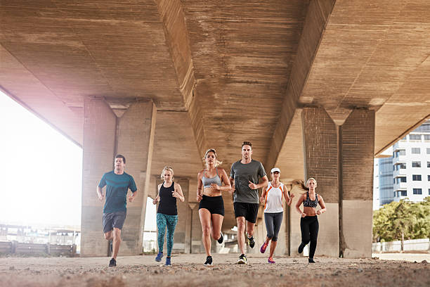 istock Group of healthy people running under a bridge 505476066