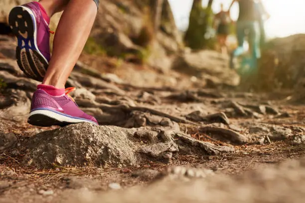 Photo of Athlete's sports shoes on a dirt track.