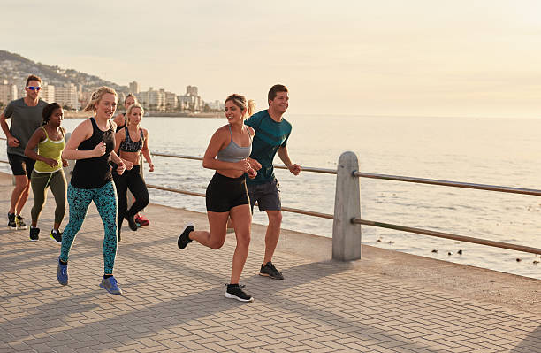 istock Young runners workout along a seaside promenade 505476934