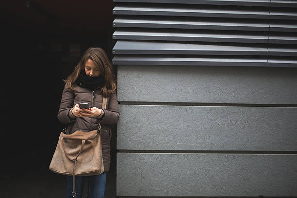 istock Woman using phone in the city 505477050