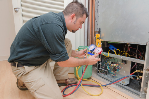 HVAC technician charging a heat pump with refrigerant