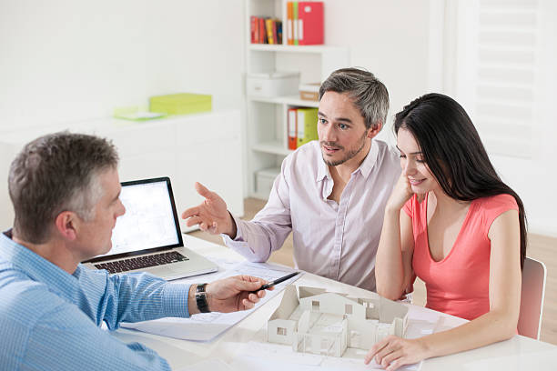 Young couple meeting construction planner
