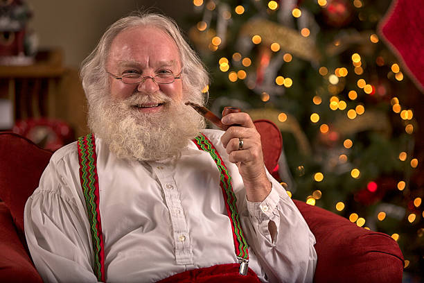 istock Santa Claus sitting at home and smoking a pipe 505482985