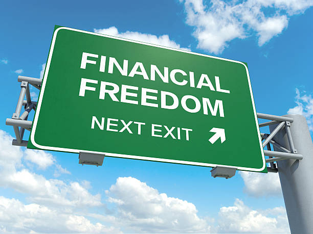 financial freedom A road sign with financial freedom words on sky background coronation photos stock pictures, royalty-free photos & images