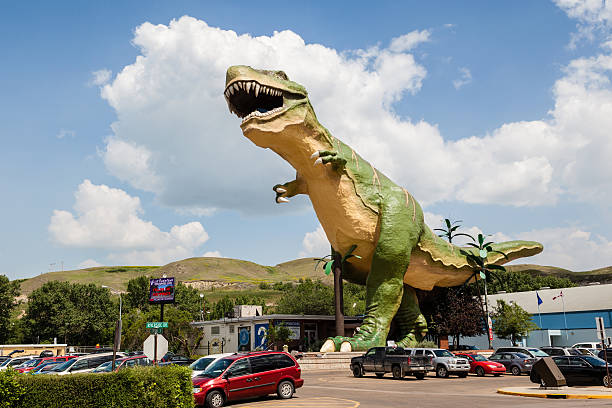World's Largest Dinosaur in Drumheller, Canada Drumheller, Canada - July 7, 2014: The world's largest dinosaur model stands at 86 ft tall and 151 ft long in Drumheller July 7, 2014. The iconic T-Rex marks the entrance to the town's visitor center and the area's worldwide fame for palaeontology research. drumheller stock pictures, royalty-free photos & images