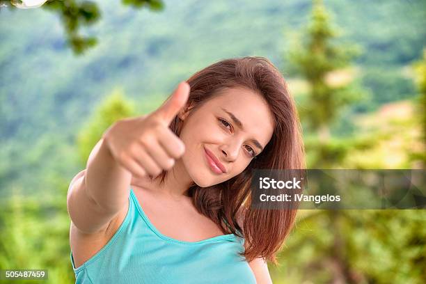 Beautiful Young Woman Giving Thumbs Up Sign In The Mountains Stock Photo - Download Image Now