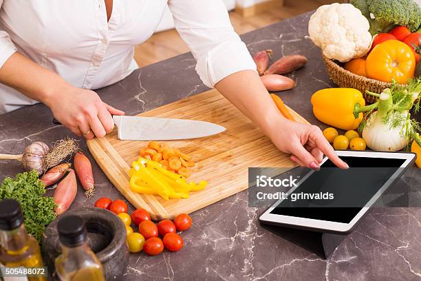 Woman Following The Recipe In Tablet Stock Photo - Download Image Now - Cooking, Digital Tablet, One Woman Only