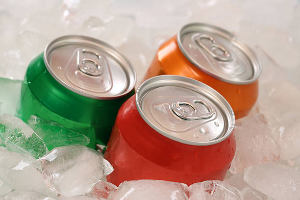 istock Cold cola and lemonade in cans on ice cubes 505488873