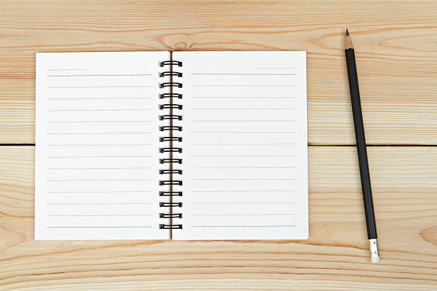 istock Notebook and pencil on wooden background. 505489430