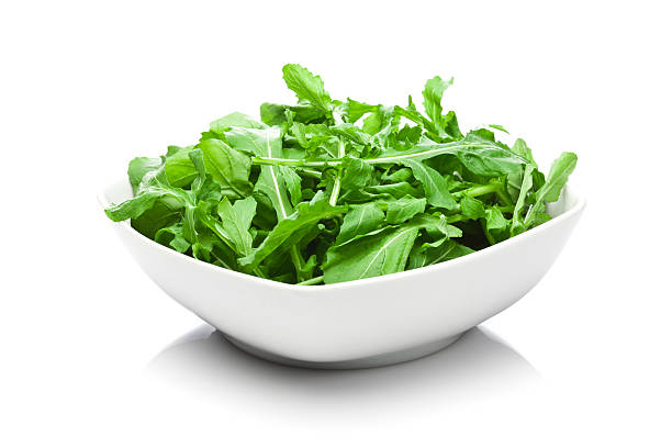 istock Organic arugula bowl isolated on white background 505492170