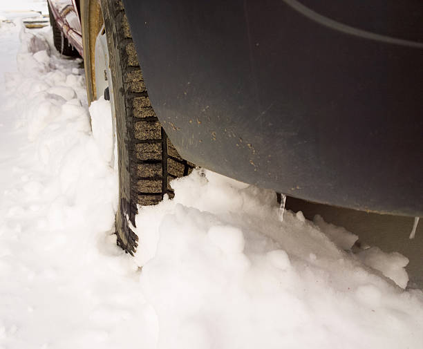 istock Car tires on winter road. 505492456