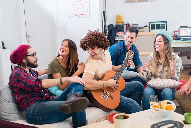 istock friends playing guitar and having fun 505493488