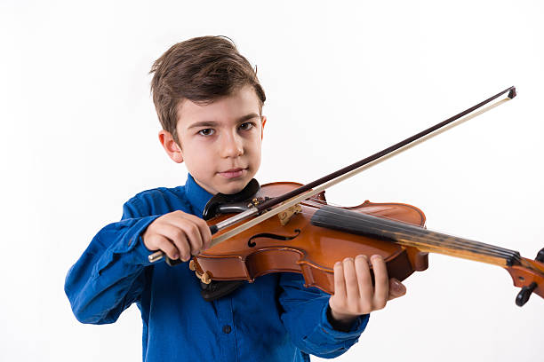 istock little handsome boy with the violin 505493976