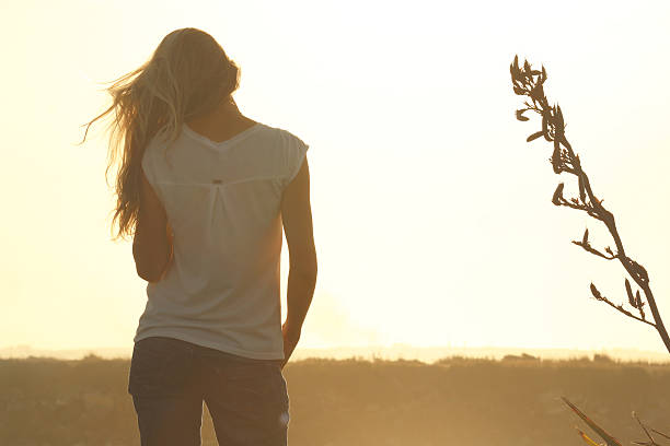 Beautiful woman enjoying sunset on the beach