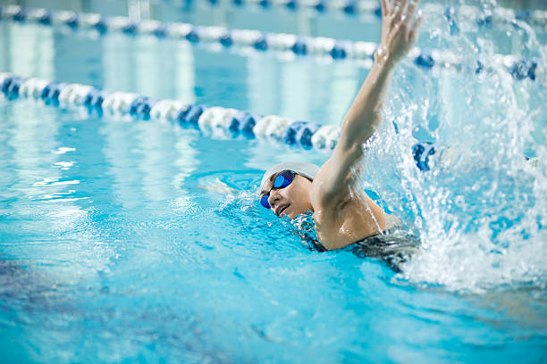 istock Young girl in goggles swimming front crawl stroke style 505496618