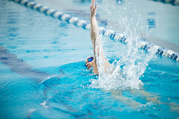 istock Young girl in goggles swimming front crawl stroke style 505496694