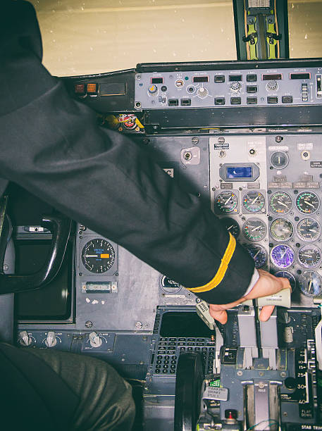 istock Rear view of pilot in aircraft cabin. 505501889