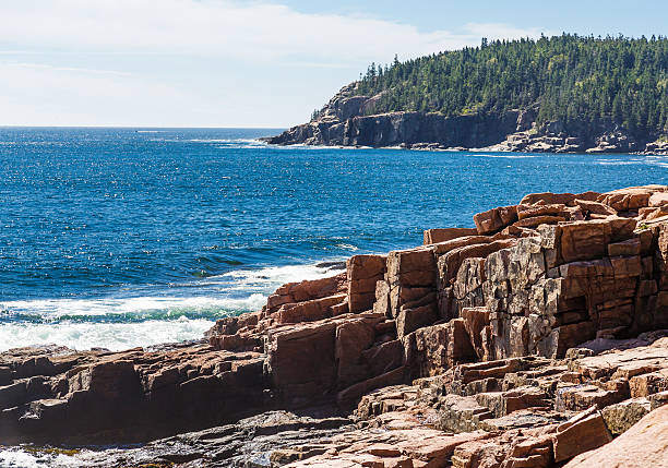 istock Green Hills Beyond Blue Water and Rocky Coast 505502671