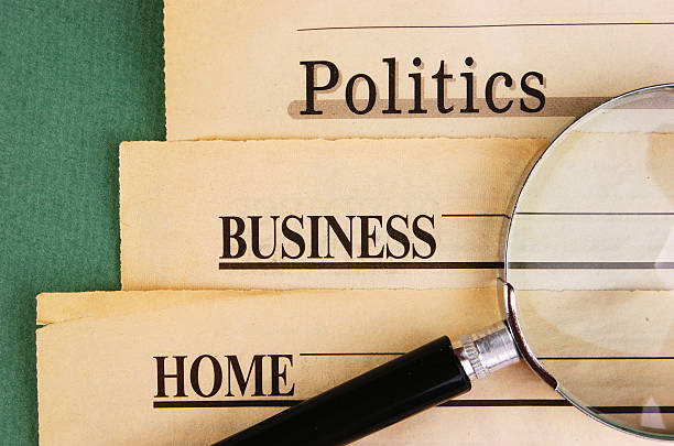 istock old newspaper and magnifying glass on a green background 505505651