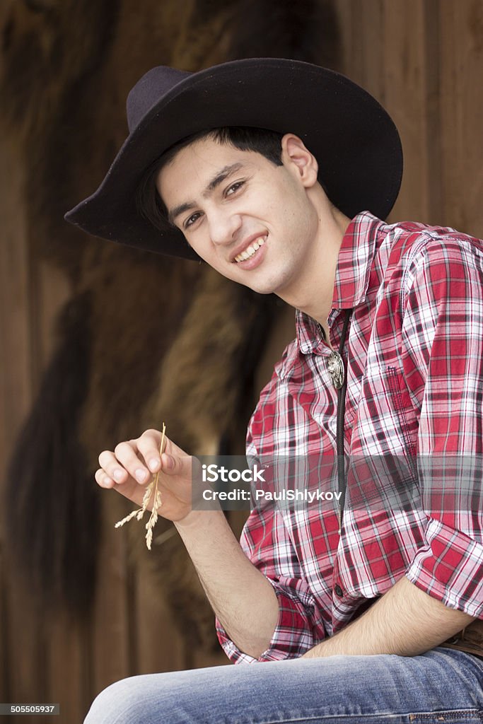 Cowboy having rest Cowboy having rest with straw in mouth Adult Stock Photo