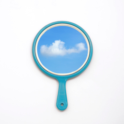 hand mirror with reflection of blue sky and cloud isolate on white