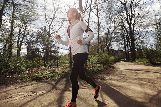 istock Fit female model jogging in forest 505507361
